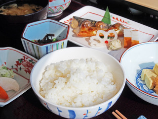 Japanese breakfast with rice, miso soup, grilled fish and seaweed