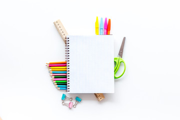 Education mockup with pupil's stationery and textbook on white background top view