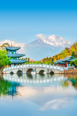 Black Dragon Pond Park. Jade Dragon Snow Mountain, chinese pavilion and bridge. Located in Lijiang,...
