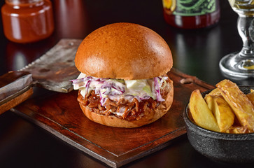 Pulled pork sandwich on rustic decorated scene