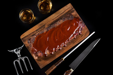 Barbecue sauce ribs on rustic cutting board