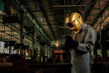 Worker welder working welding gas steel in industry with safety mask gloves and safety equipment....