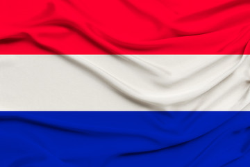 national flag of the country Holland on gentle silk with wind folds, travel concept, immigration, politics, copy space, close-up