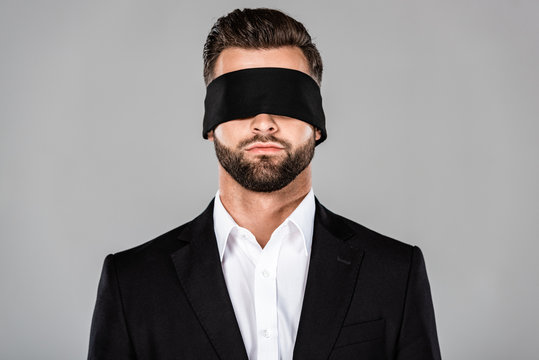 Mysterious image of a blindfolded man in a dark room stock photo