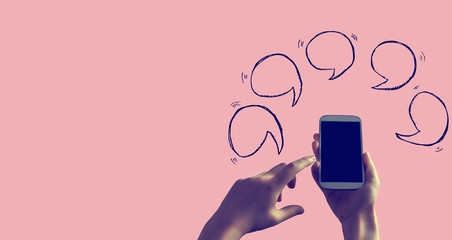 Speech bubbles with person holding a white smartphone