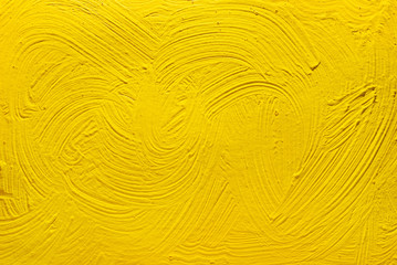 Abstract yellow background from acrylic paints. Concrete background.