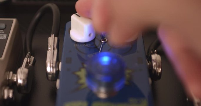 Guitarist Adjusting Knobs And Switches On Reverb Guitar Effect Pedal. Music Related 4K Concept