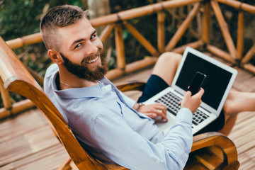 Young handsome man Using Laptop in cafe, outdoor portrait business woman, hipster style, internet,...