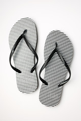 Pair of black and white stripe flip flops isolated on white background