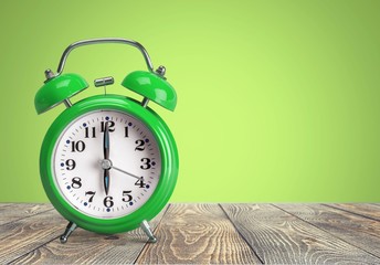 Retro alarm clock on table  background
