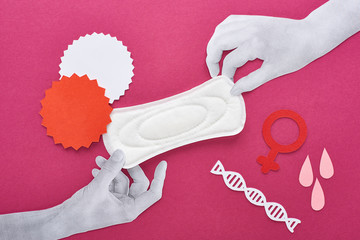 paper cut white hands with white sanitary napkin near blood drops, empty cards and female signs on...