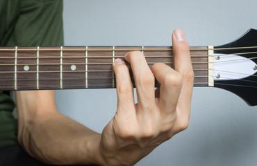 Guitar Player Hand in F Major Chord on Acoustic Guitar