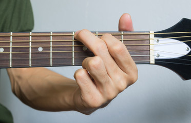 Guitar Player Hand in G Major Chord on Acoustic Guitar in Front View