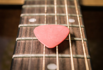 Red Pick on Acoustic Guitar String in Vintage Tone