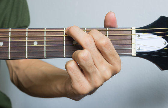 Guitar Player Hand in G Major Chord on Acoustic Guitar in Front View