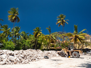 Excavator on construction site with pile of stones - obrazy, fototapety, plakaty