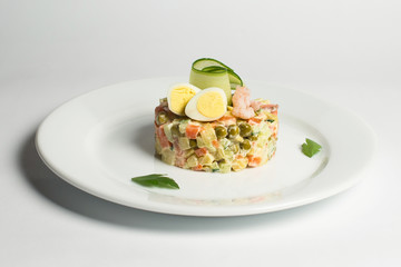 Russian salad on a white plate
