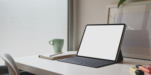 Fototapeta na wymiar Minimal comfortable workplace with blank screen tablet