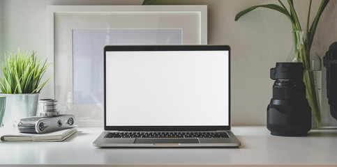 Fototapeta premium Trendy photographer workplace with laptop and vintage camera