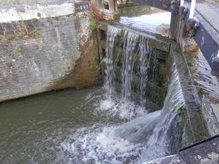Water pouring from leaking lock gate on Grand Union canal
