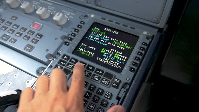 Pilot checking parameters on MCDU-multipurpose control display unit