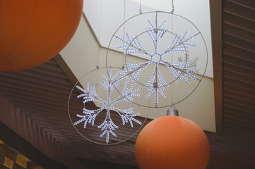 New Year and Christmas ceiling decorations in the mall. decoration with huge snowflakes to create a...