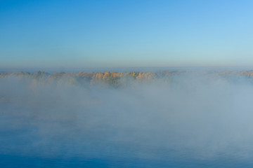 Obraz na płótnie Canvas Fog over the water on a river Dnieper on autumn