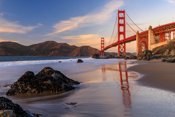 Golden Gate Bridge view from the hidden and secluded rocky Marshall's Beach at sunset in San...