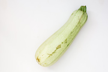 Summer harvest of vegetables concept. Zucchini on a light white background.
