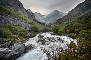 Hiker with backpack in the mountains