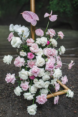 Blooming decoration of wedding arch of pastel orchid, rose and anthurium flowers. Pink and coral colors. Floral concept.