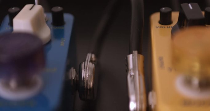 Multiple Colorful Guitar Effect Pedals. Camera Slowly Panning. Dolly Shot. Music Related 4K Concept