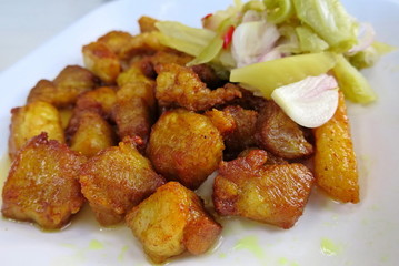 Deep fried pork belly with fish sauce on white plate. Thai food style concept.
