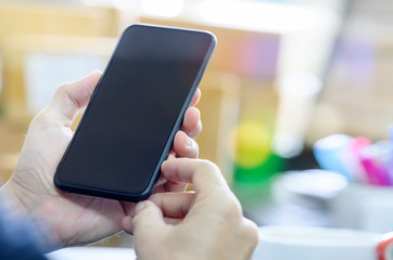 Man using smartphone with blank screen. Blank screen for graphics display montage.