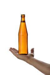 male hand holding brown beer bottle without label isolated on white background. man offers a bottle of beer