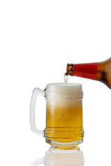 pouring beer into glass on white background