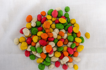 colored, glazed peanuts. Close-up. View from above. Salted peanuts for beer.