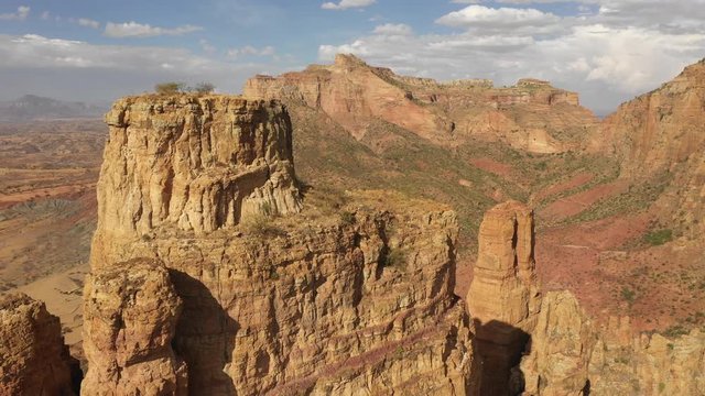 Flying over rock formations towards panoramic mountain landscape in Tigray region in Ethiopia