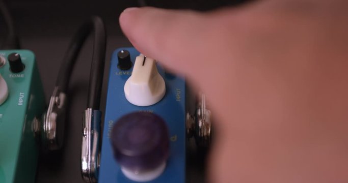 Guitarist Adjusting Knobs And Switches On Guitar Effect Pedals. Dolly Shot. Music Related 4K Concept