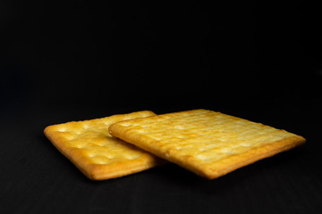 Cracker cookies on dark background.