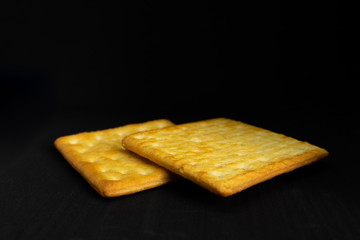 Cracker cookies on dark background.
