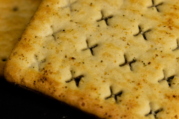 Cracker cookies on dark background.