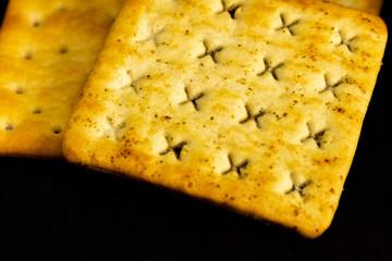 Cracker cookies on dark background.