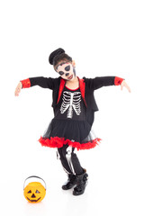 Portrait adorable Asian young girl dress skeleton and witch costume with black hat isolated background