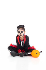 Portrait adorable Asian young girl dress skeleton and witch costume with black hat isolated background