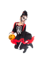 Portrait adorable Asian young girl dress skeleton and witch costume with black hat isolated background