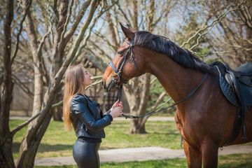 Obraz premium Woman with a horses on farm, pets animals in village on a rancho. Horses are human friends