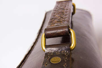 Black leather bag handle close up shot isolated on white background.