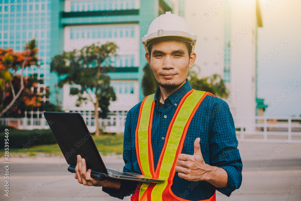 Poster engineer holding computer working on side technology
