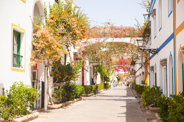 Fototapeta na wymiar Gran Canaria, Spain - Typical architecture of Puerto de Mogan, a small fishing port of Gran Canaria. Colorfull flowers blooming around houses.